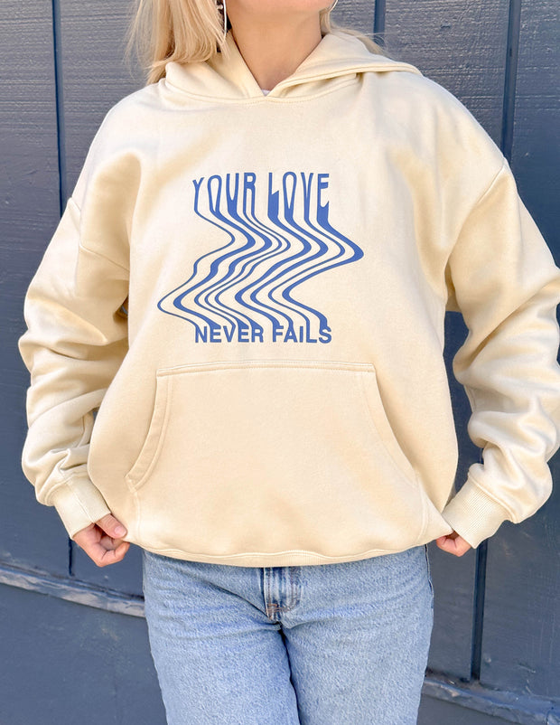 Love Never Fails Cream Unisex Hoodie Christian Sweatshirt