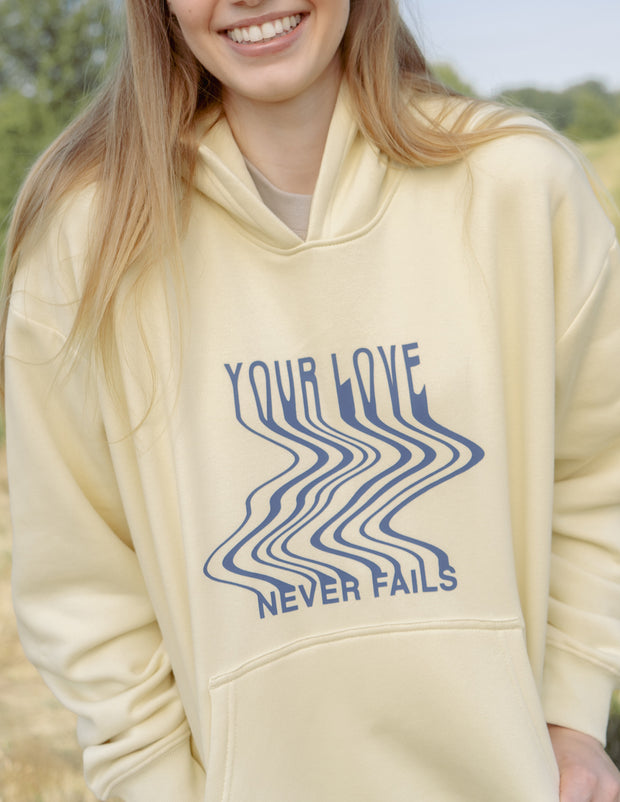 Love Never Fails Cream Unisex Hoodie Christian Sweatshirt