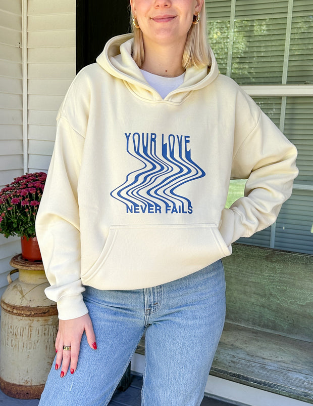 Love Never Fails Cream Unisex Hoodie Christian Sweatshirt